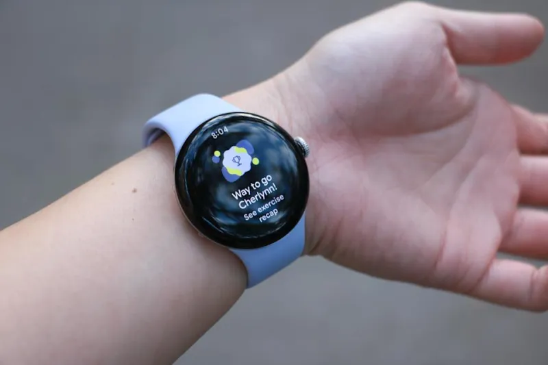 The Pixel Watch 4 on a wrist, with its screen showing a trophy graphic and the words 