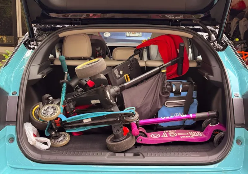 Here you can see a Doona tricycle, two scooters and a cooler.